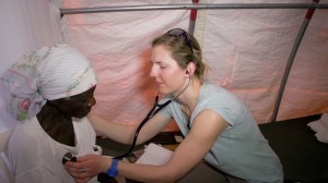 Dr. Brianne examines a patient at the Hotes Foundation medical clinic in Haiti.