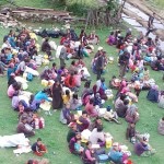 nepalese people sit on grass