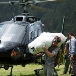 men moves bag from helicopter