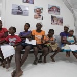 haitian woman and children sit