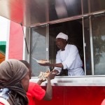 chef james serves people red food truck