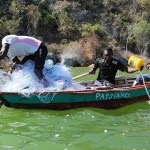 haitian villagers fish on green boat