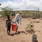 woman and child hold bucket water