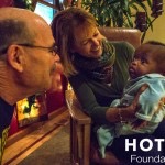 richard hotes looks at woman holding baby