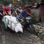 men help push rice cart