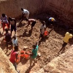 men dig water collection pit